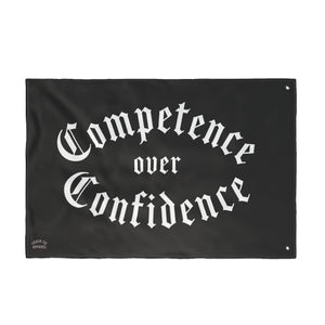 Competence over Confidence flag laid flat showing the reinforced metal grommets at each corner