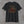 Black 9/11 25th anniversary tee, back print: faded American flag with rust-red Twin Towers and city skyline