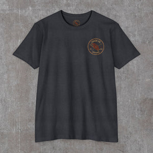 Front of the charcoal Truck Co. Apparel tee with the round TCA ladder-and-hook crest on the left chest