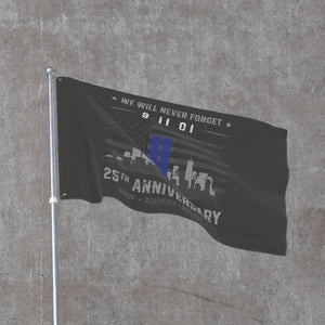 Greyscale 9/11 memorial flag rippling on a flagpole, Twin Towers in blue against the skyline