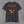 Back of the charcoal Honor the Tradition tee: eagle over flag stripes above the EST. 2026 banner