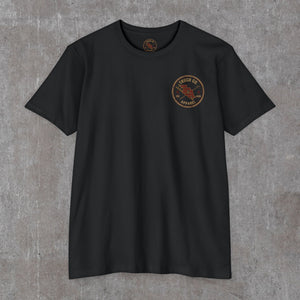 Front of the black Truck Co. Apparel tee with the round TCA ladder-and-hook crest on the left chest