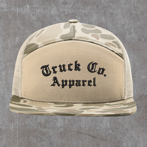 Richardson 168P seven-panel trucker hat in Harvest Duck Camo and sandstone, Truck Co. Apparel embroidered in black blackletter across the front panel