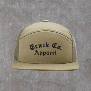 Richardson 168 seven-panel trucker hat in Pale Khaki with loden mesh, Truck Co. Apparel embroidered in black blackletter across the front panel
